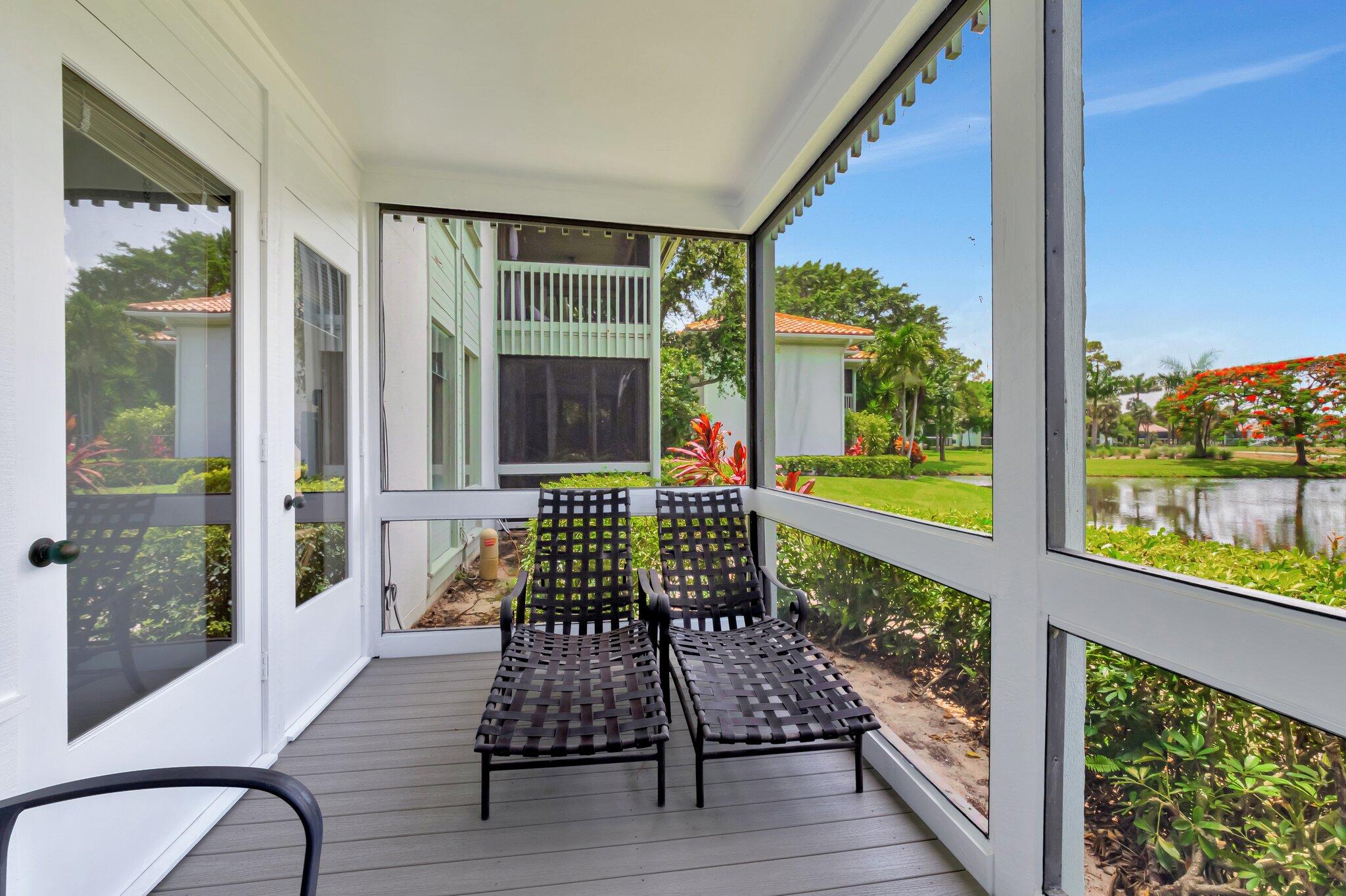 19819 Boca W Drive, Unit 4033 Boca Raton, FL 33434 - Photo 5 of 58 a view of a chair and tables in the balcony