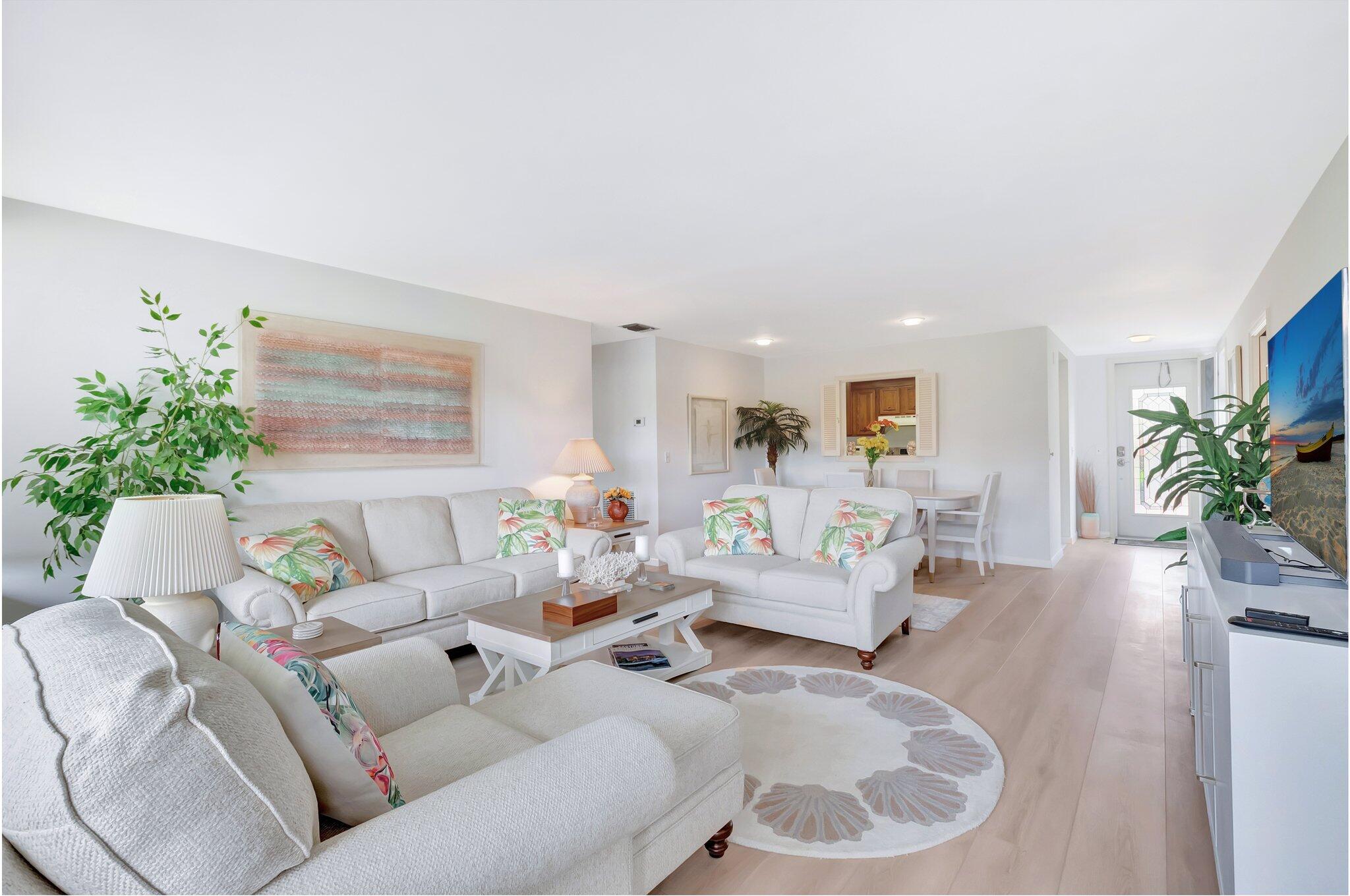 19819 Boca W Drive, Unit 4033 Boca Raton, FL 33434 - Photo 8 of 58 a living room with furniture and a potted plant