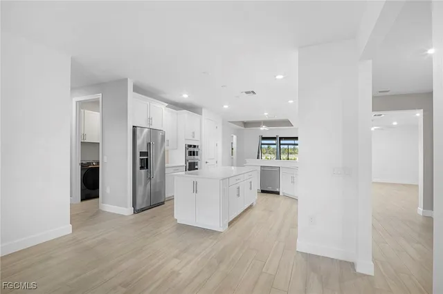 a kitchen with stainless steel appliances a refrigerator and a stove top oven