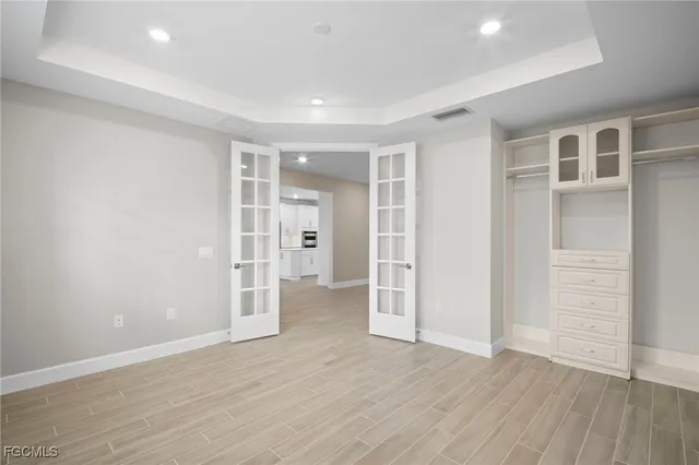 a view of empty room with wooden floor