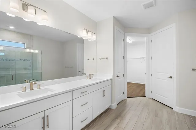 a bathroom with a double vanity sink mirror and