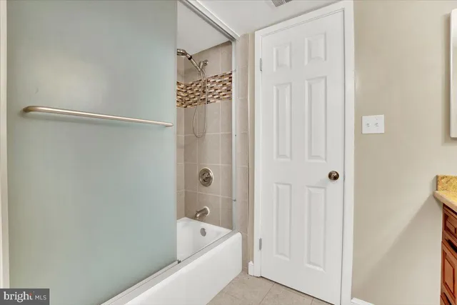 a bathroom with a bathtub and shower