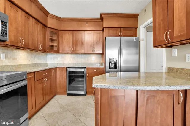 a kitchen with kitchen island granite countertop wooden cabinets a sink and dishwasher