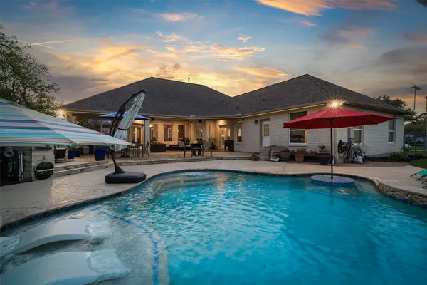 a view of a house with swimming pool and sitting area