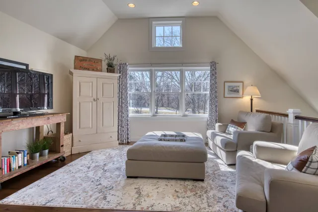 a bedroom with furniture and a fireplace