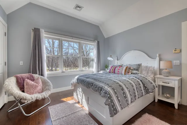 a bedroom with a bed and a chair