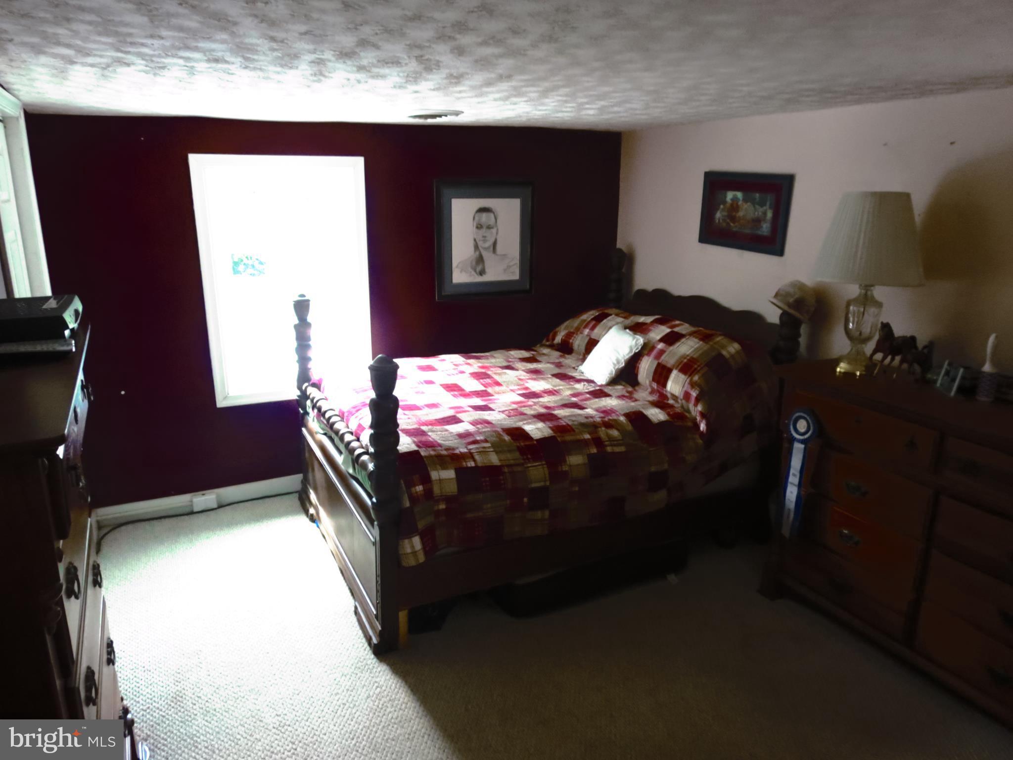 4166 Middleburg Road Union Bridge, MD 21791 - Photo 17 of 29 a bed sitting in a bedroom next to a window
