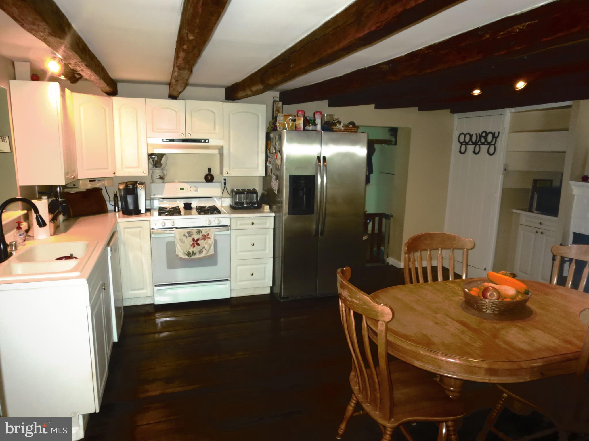 4166 Middleburg Road Union Bridge, MD 21791 - Photo 6 of 29 a kitchen with stainless steel appliances granite countertop a sink a stove a refrigerator with a dining table and chairs