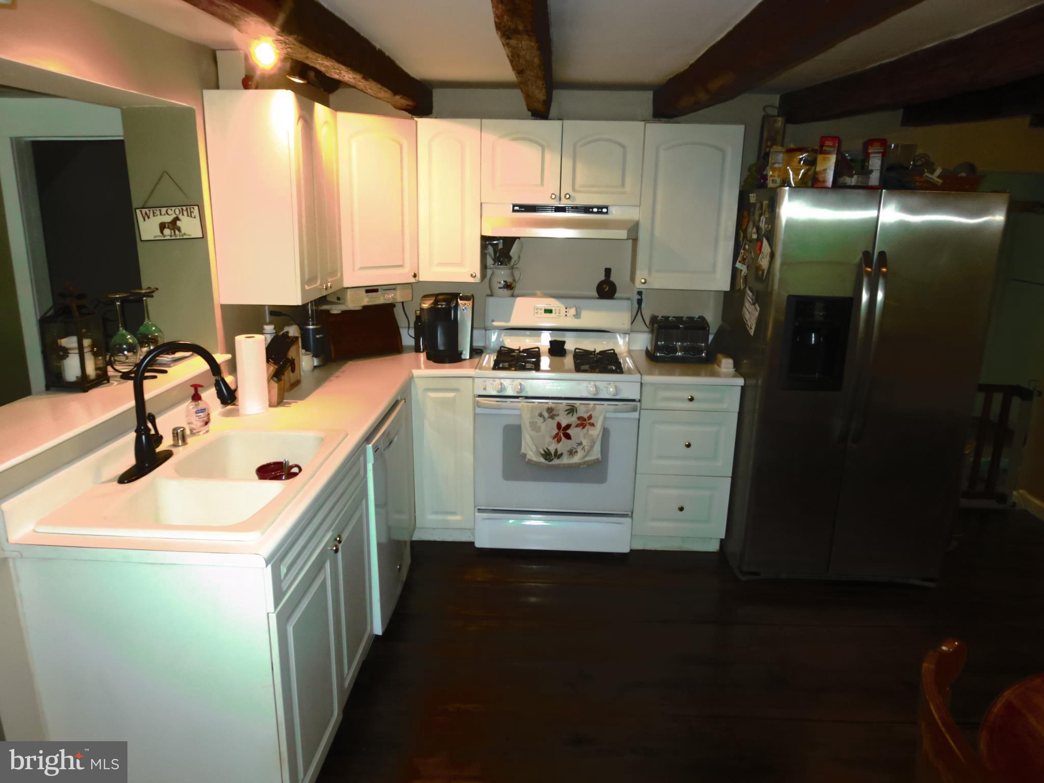 4166 Middleburg Road Union Bridge, MD 21791 - Photo 7 of 29 a kitchen with a sink stove and refrigerator