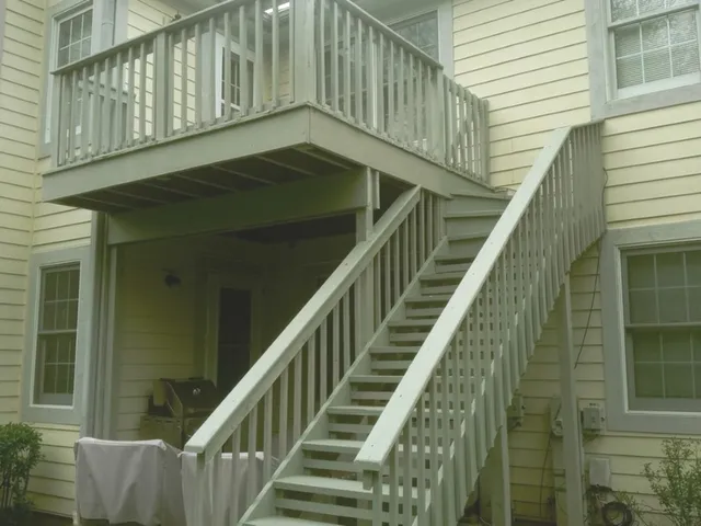 a view of balcony with wooden floor and stairs