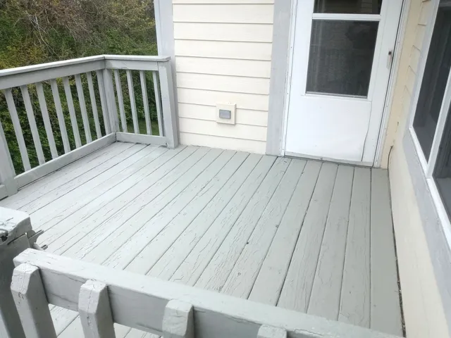 a view of a balcony with wooden floor