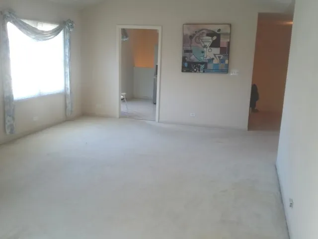 an empty room with windows and closet