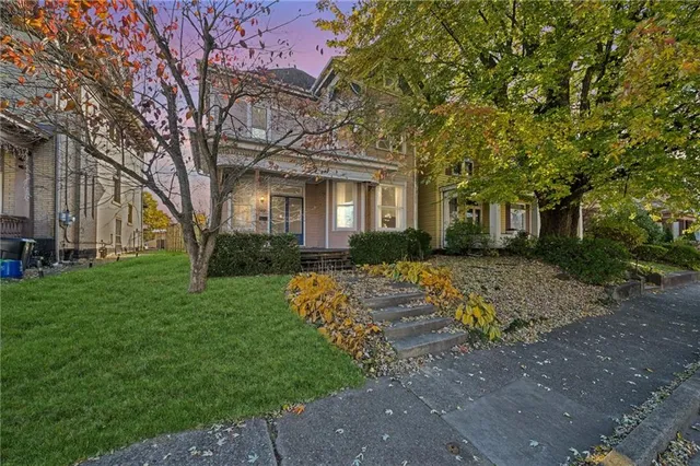 a front view of a house with garden