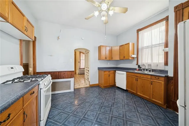 a kitchen with stainless steel appliances granite countertop a sink and a stove