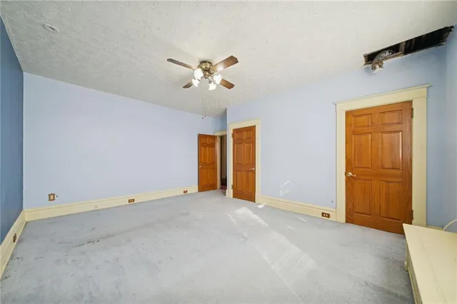 a view of room with hardwood floor and ceiling fan