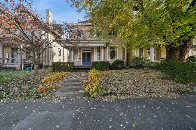 a front view of a house with garden