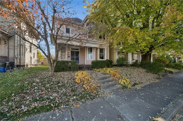 a front view of a house with a garden