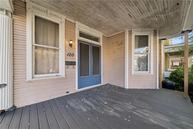 a view of a house with a wooden deck
