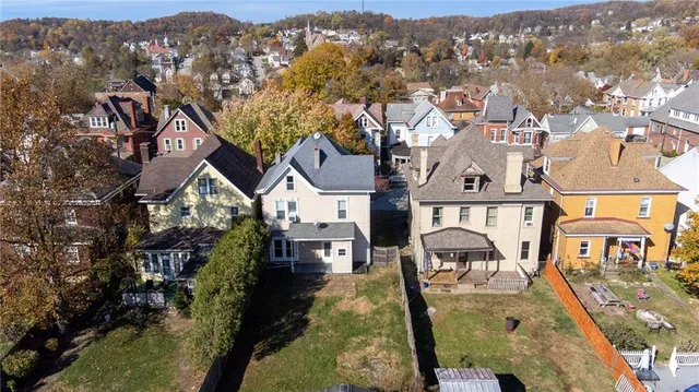 an aerial view of multiple houses with a yard