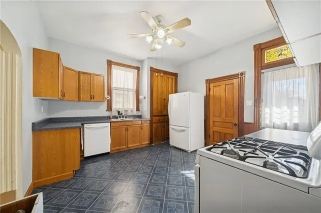 a kitchen with a stove a refrigerator and cabinets