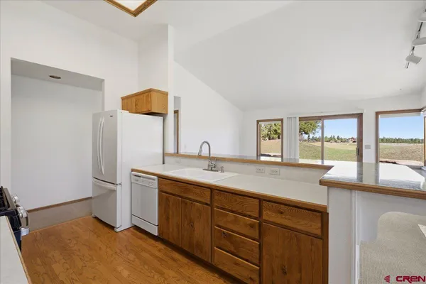 a view of an empty room with a fireplace and a window