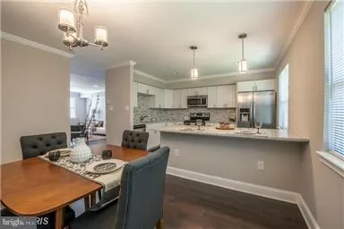 a view of a dining room with furniture and chandelier