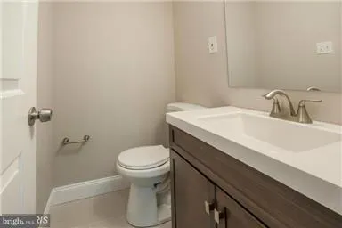 a bathroom with a sink toilet and vanity