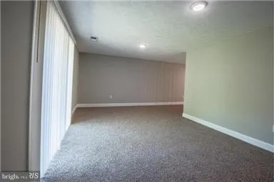 a view of a big room with closet and windows