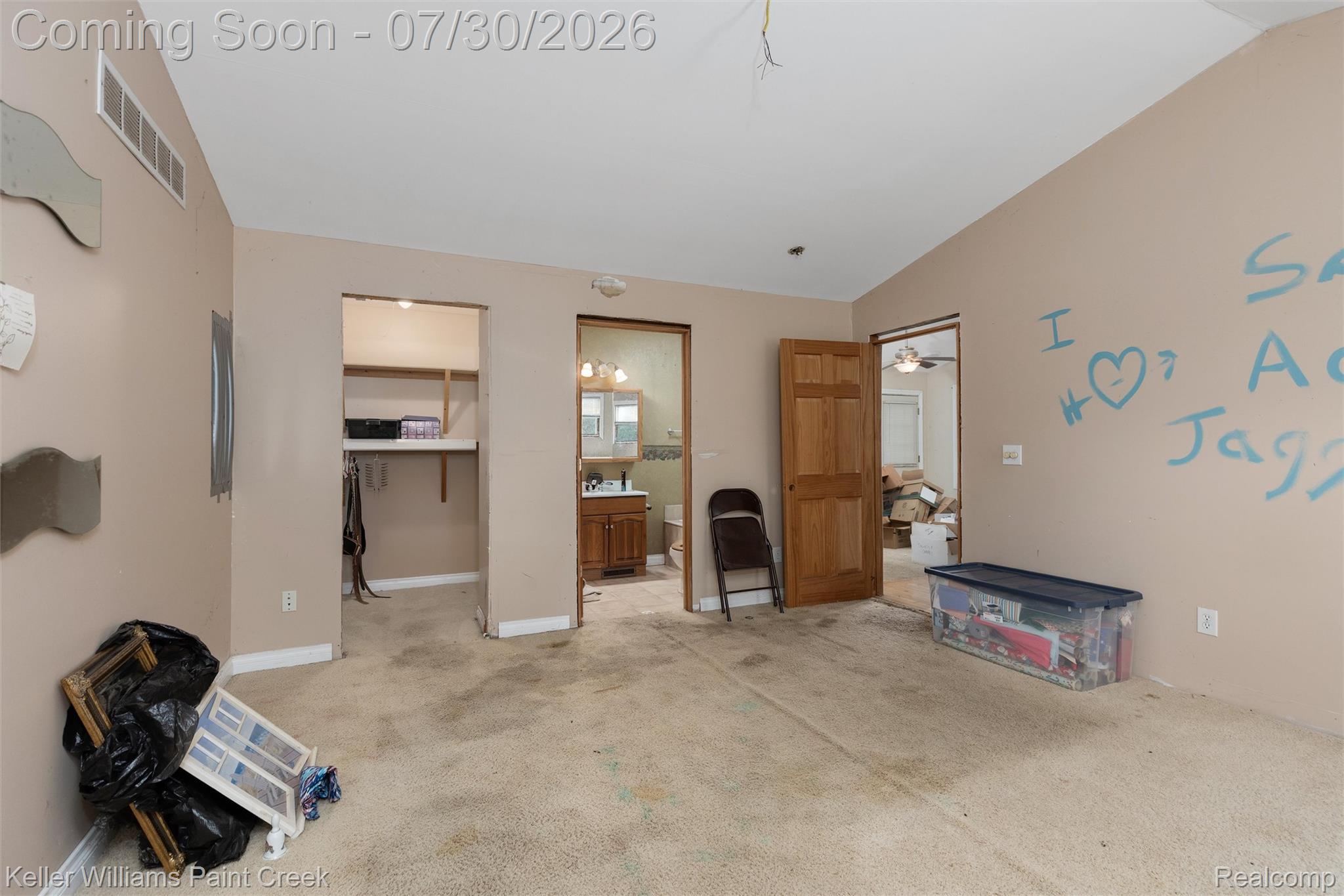 7544 Ravenswood Road Goodells, MI 48027 - Photo 20 of 42 Spacious interior room featuring a vaulted ceiling and wall-to-wall carpeting