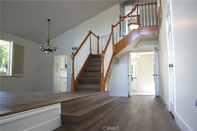 a view of staircase with white walls and a window