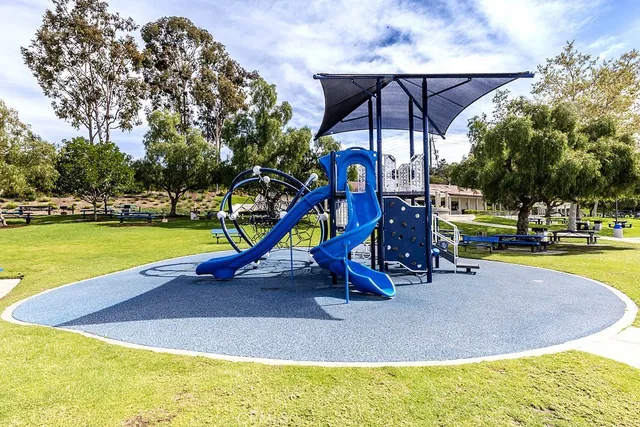 a view of swimming pool with lawn chairs and a big yard