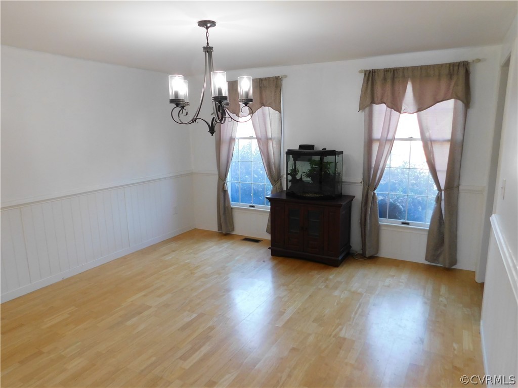 4410 Dunraven Road Chesterfield, VA 23236 - Photo 16 of 41 a view of a livingroom with furniture wooden floor and chandelier
