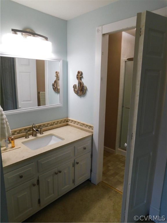 4410 Dunraven Road Chesterfield, VA 23236 - Photo 29 of 41 a bathroom with a granite countertop sink and mirror