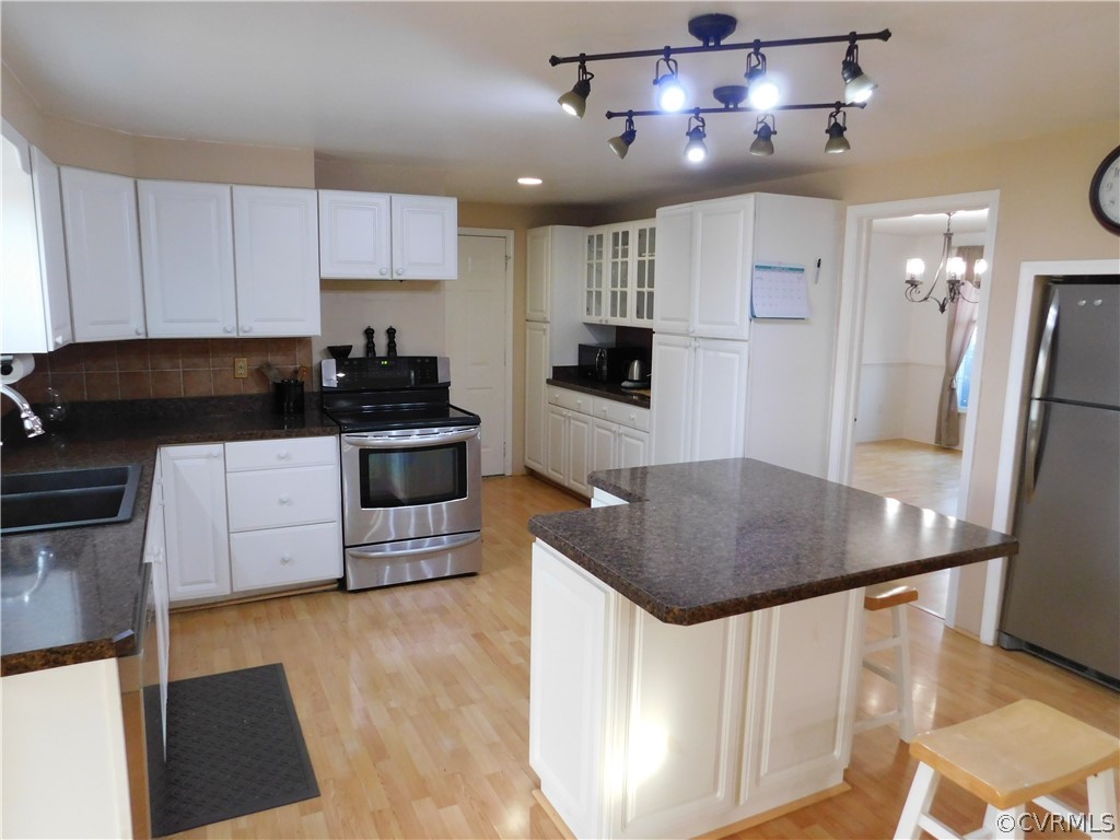 4410 Dunraven Road Chesterfield, VA 23236 - Photo 6 of 41 a kitchen with stainless steel appliances granite countertop a stove a refrigerator a sink a microwave a counter and cabinets