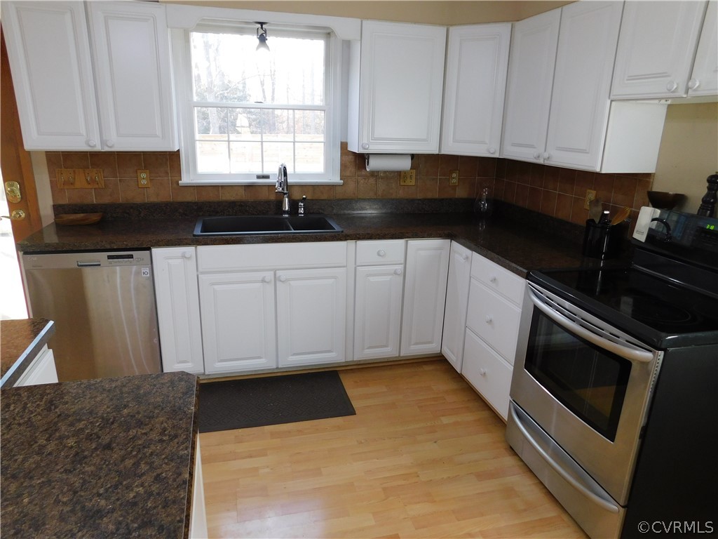4410 Dunraven Road Chesterfield, VA 23236 - Photo 7 of 41 a kitchen with granite countertop white cabinets sink and window