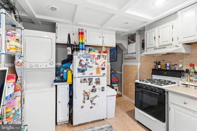 a kitchen with refrigerator and cabinets