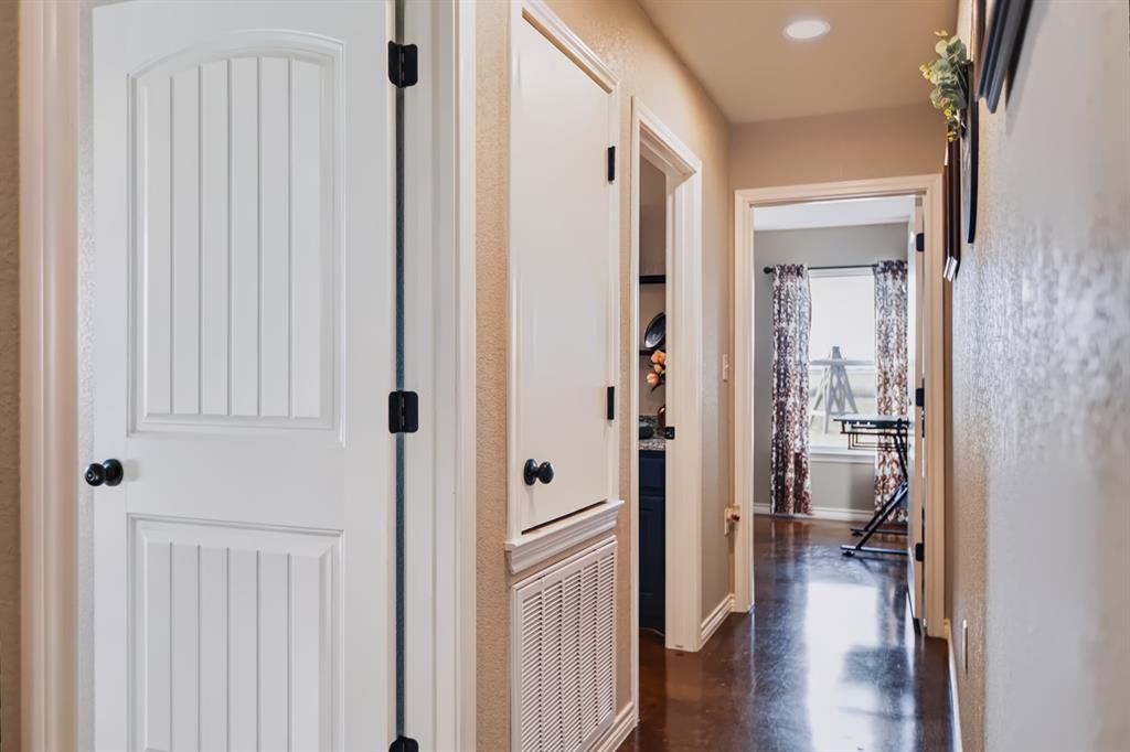 2433 Trlica Road West, TX 76691 - Photo 17 of 40 Hallway featuring recessed lighting, dark wood-finish flooring, and white paneled doors with dark hardware
