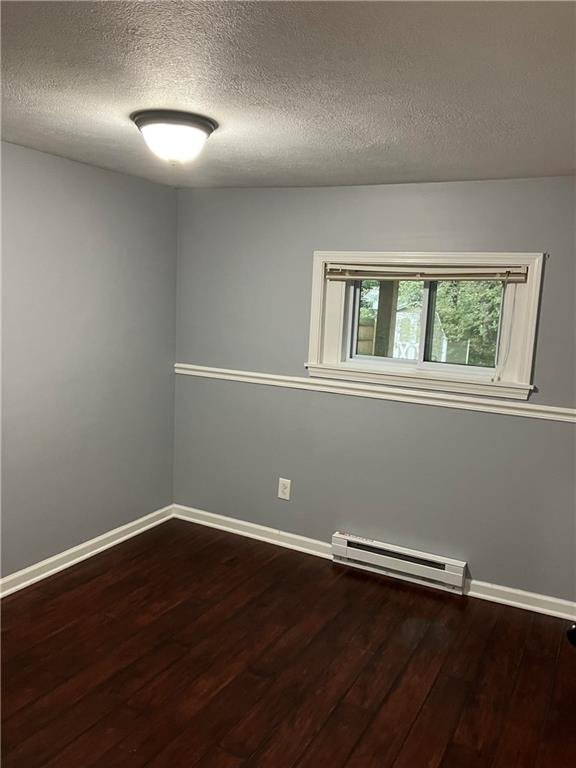 50 Village Road Slippery Rock, PA 16057 - Photo 17 of 26 an empty room with wooden floor and windows