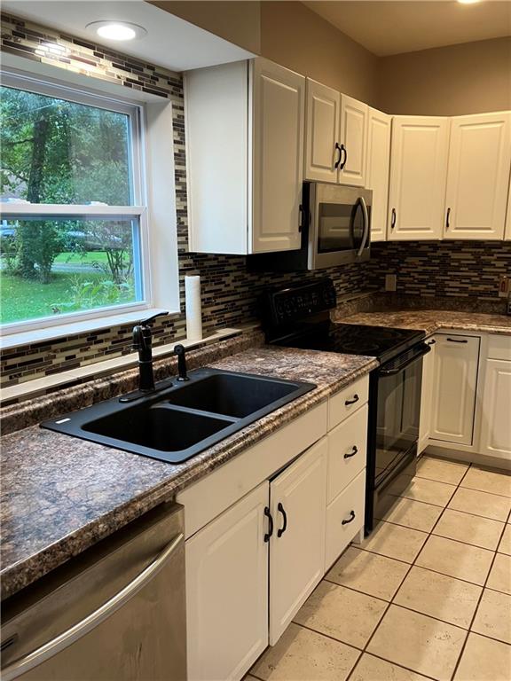 50 Village Road Slippery Rock, PA 16057 - Photo 5 of 26 a kitchen with granite countertop a sink and a stove