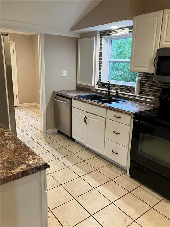 50 Village Road Slippery Rock, PA 16057 - Photo 6 of 26 a kitchen with granite countertop a stove a sink and a microwave