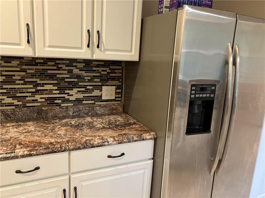 50 Village Road Slippery Rock, PA 16057 - Photo 9 of 26 a kitchen with granite countertop a refrigerator and a stove