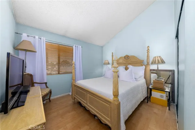 a bedroom with a bed and flat screen tv