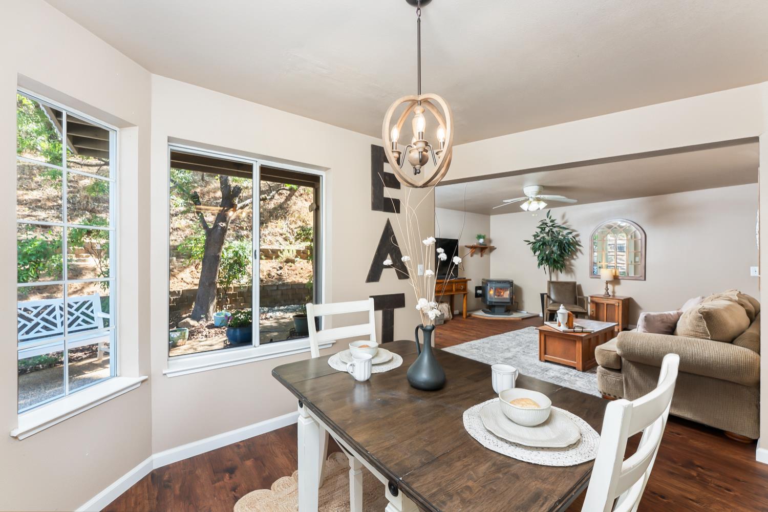 3472 See View Court Rescue, CA 95672 - Photo 20 of 56 a outdoor dining area with furniture a chandelier and wooden floor