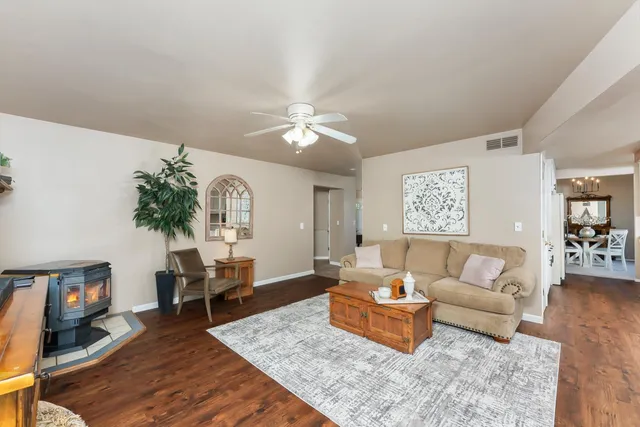 a living room with furniture a flat screen tv and a large window