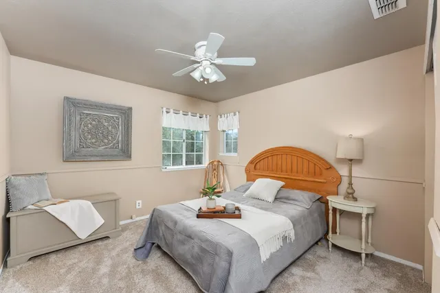 a bedroom with a bed and a window