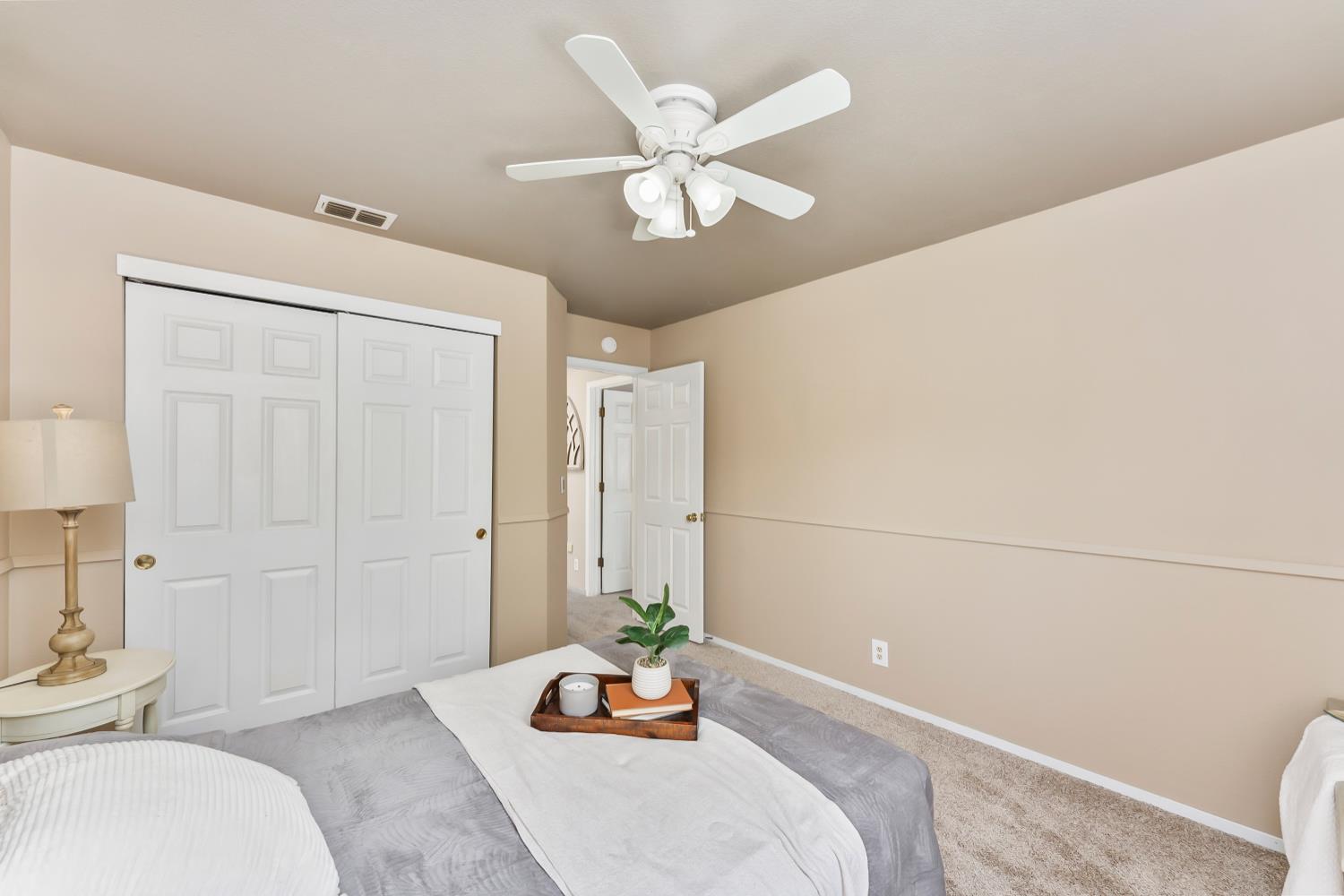 3472 See View Court Rescue, CA 95672 - Photo 26 of 56 a bedroom with a bed and a chandelier fan
