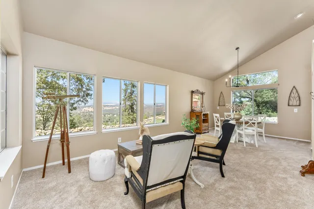 a dining room with furniture and a large window