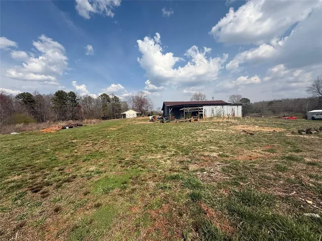 a view of a lake with table and chairs