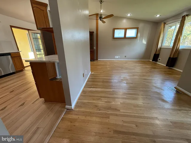 a view of a hallway with wooden floor