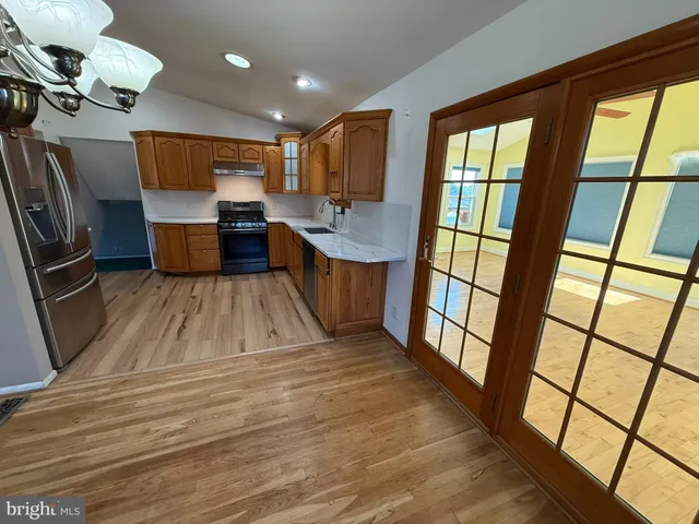 a view of kitchen with sink and wooden floor